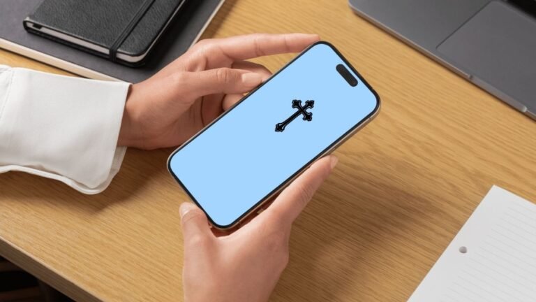 A person holding an iPhone showing a Holy Cross iPhone Wallpaper with a calming sky blue background, symbolizing peace and faith.